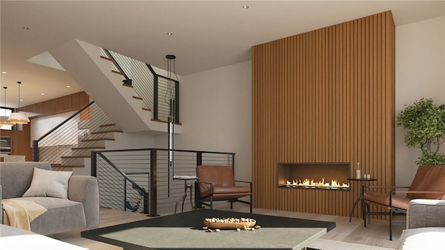 living room with a large fireplace and light hardwood / wood-style flooring