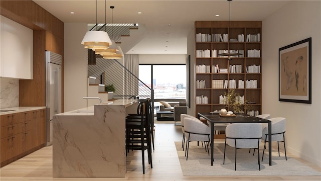 dining space with light hardwood / wood-style floors and sink