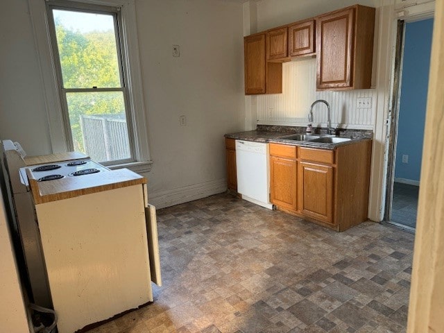 kitchen with dishwasher, sink, and range