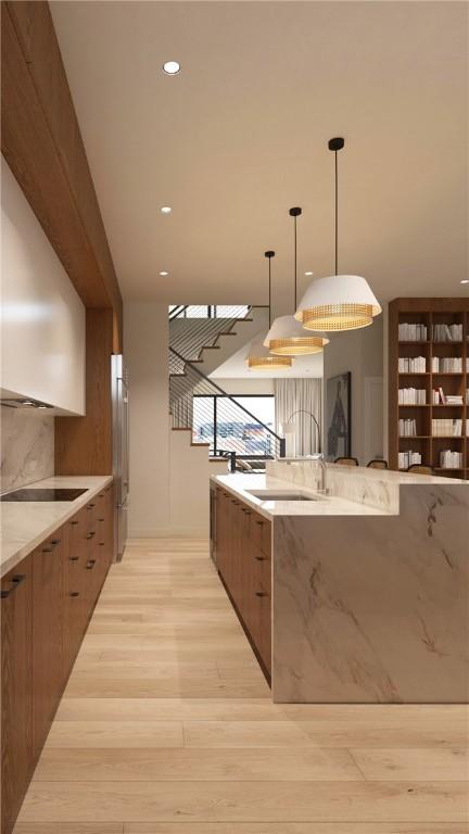 2700 Penn Unit 319, Downtown Pgh, PA 15222 - kitchen with modern cabinets, light wood-style floors, decorative light fixtures, light stone countertops, and recessed lighting