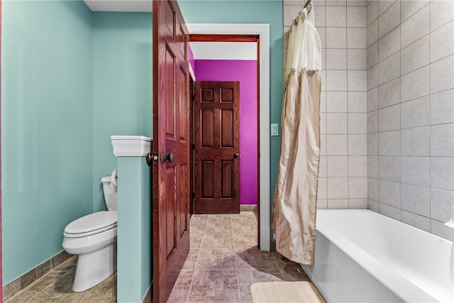 bathroom with shower / bath combination with curtain and toilet