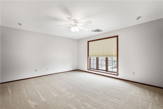 carpeted spare room featuring ceiling fan