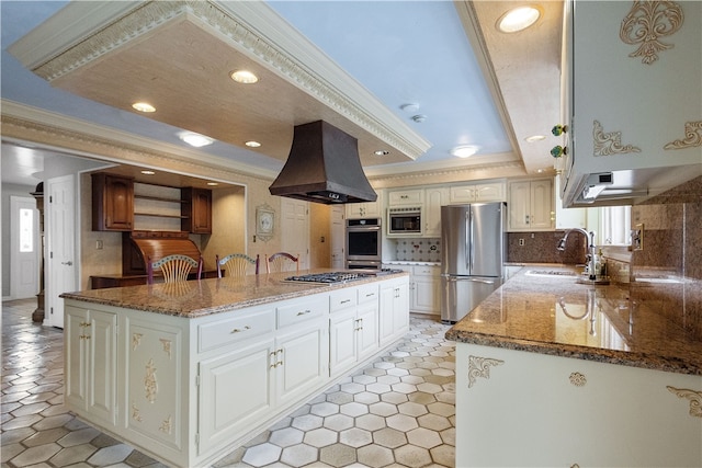 kitchen with a healthy amount of sunlight, custom exhaust hood, sink, and appliances with stainless steel finishes