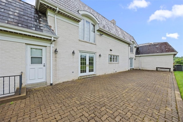 6840 Kevin Dr, Bethel Park, PA 15102 - back of house featuring french doors, mansard roof, a high end roof, a patio, and brick siding