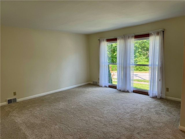 unfurnished room featuring light colored carpet