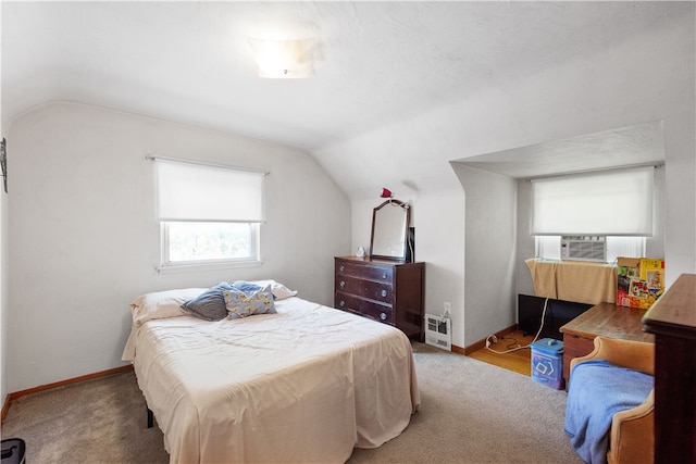 bedroom featuring lofted ceiling and carpet flooring