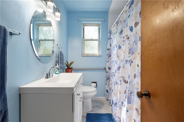 bathroom featuring vanity, toilet, and walk in shower