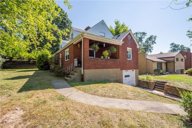 view of side of property with a garage and a lawn