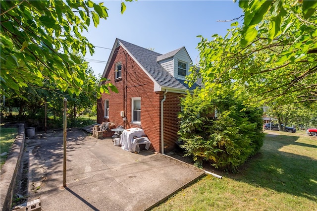 view of property exterior featuring a lawn