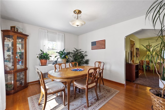 dining room with dark hardwood / wood-style floors