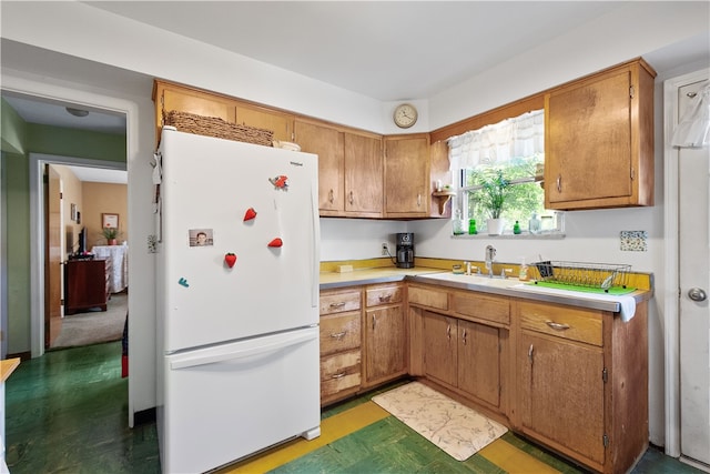 kitchen featuring white fridge and sink