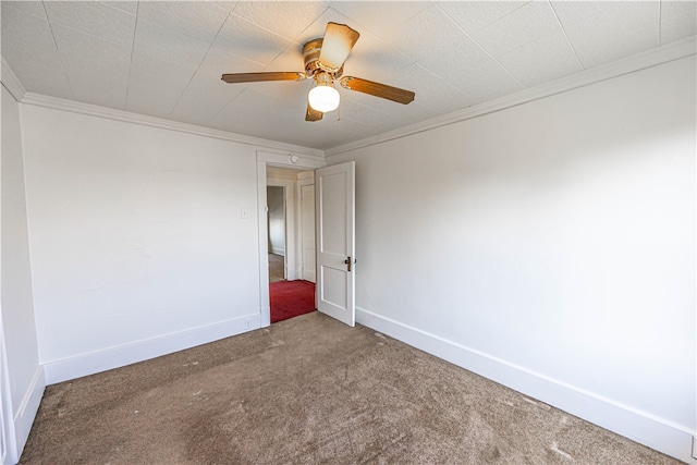 carpeted empty room featuring crown molding and ceiling fan