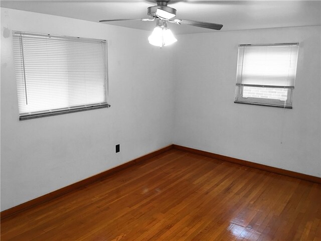 spare room with ceiling fan and hardwood / wood-style flooring