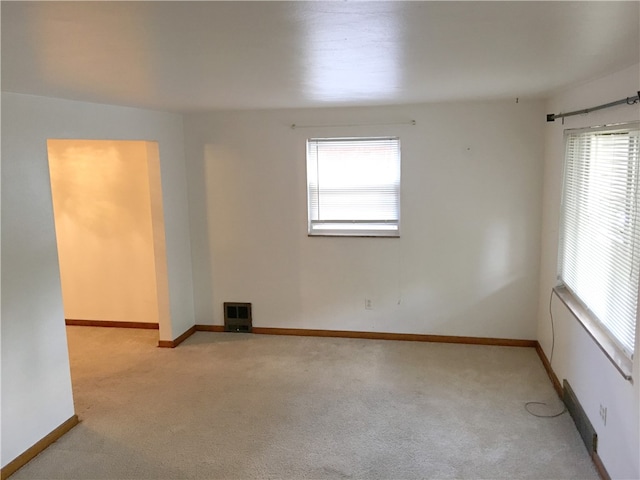 spare room with light colored carpet and plenty of natural light