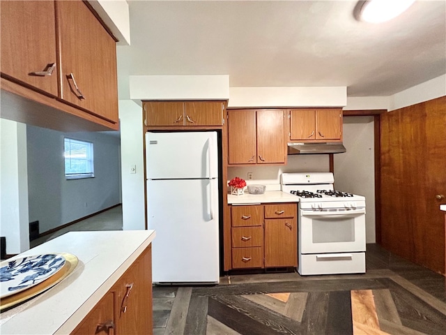 kitchen with white appliances and dark hardwood / wood-style floors