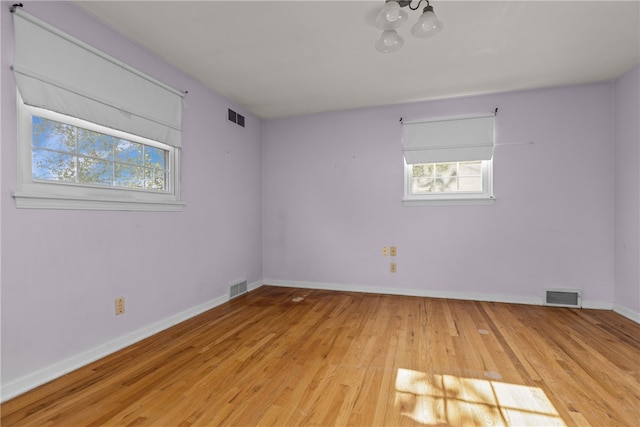 unfurnished room featuring light hardwood / wood-style floors