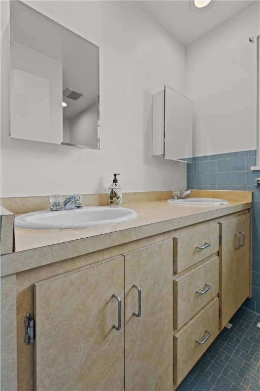 bathroom featuring vanity, tile patterned floors, and tile walls