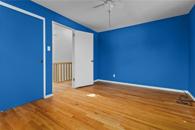 spare room with ceiling fan and light wood-type flooring