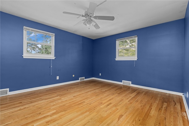 empty room with light hardwood / wood-style floors and ceiling fan