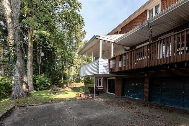 view of property exterior featuring a deck and a garage