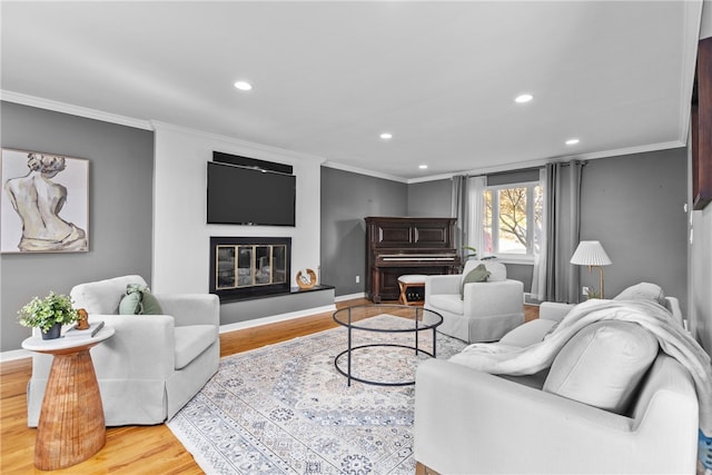 living room with crown molding and light hardwood / wood-style floors