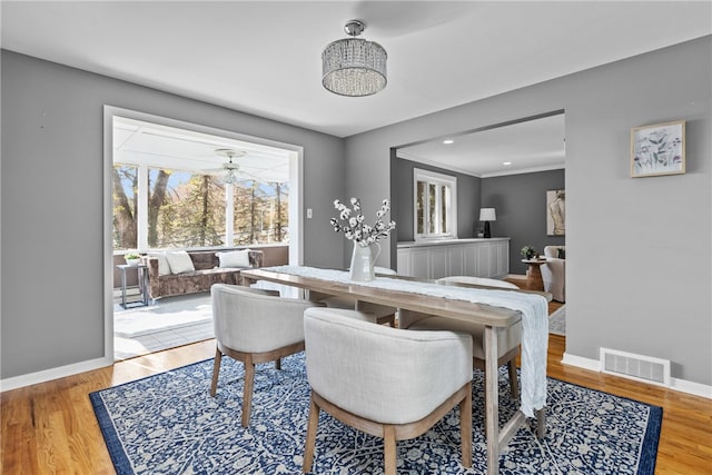 dining area with hardwood / wood-style floors and ceiling fan