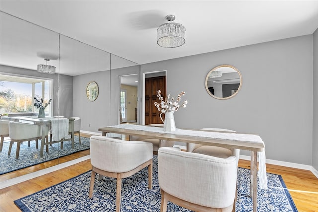 dining space with wood-type flooring