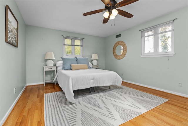 bedroom with wood-type flooring and ceiling fan