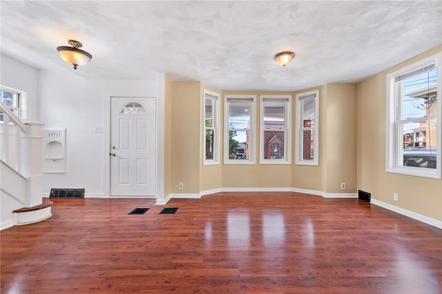 foyer featuring a textured ceiling and hardwood / wood-style flooring