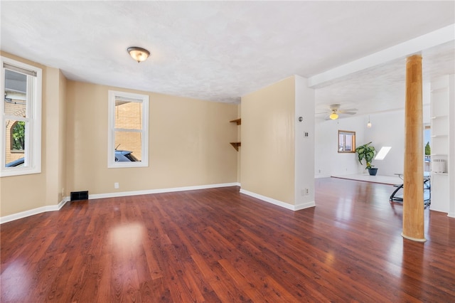 empty room with dark wood-type flooring, ceiling fan, and a textured ceiling