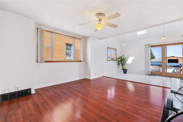 spare room with light wood-type flooring and ceiling fan