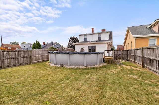 view of yard with a covered pool