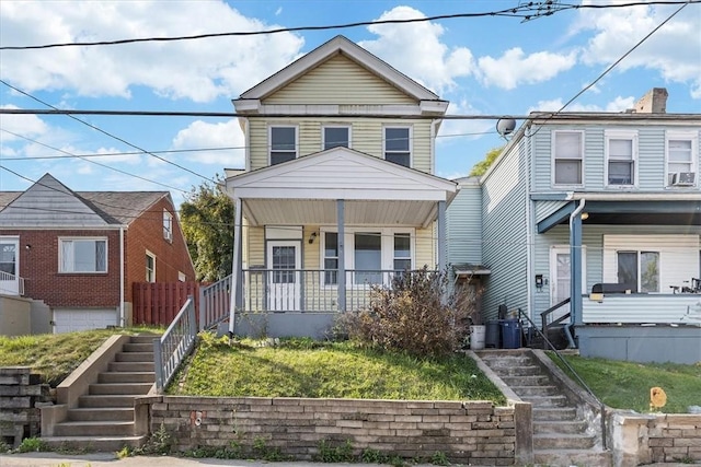 view of front of home with a porch and stairway