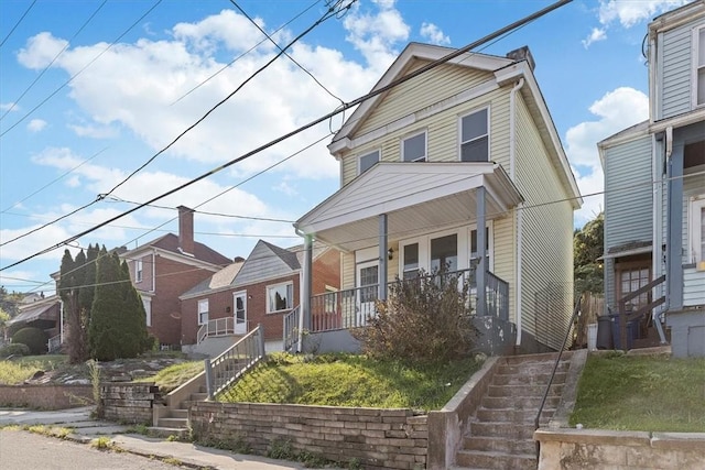 view of front of house with covered porch and stairs