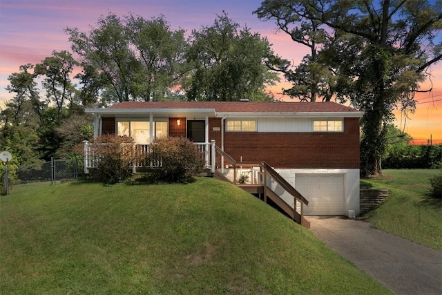 ranch-style home with a yard and a garage