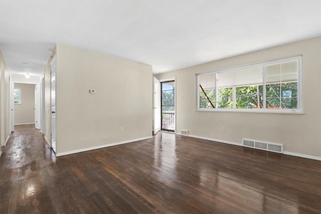 unfurnished room with dark hardwood / wood-style flooring