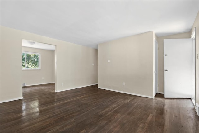 spare room featuring dark hardwood / wood-style flooring