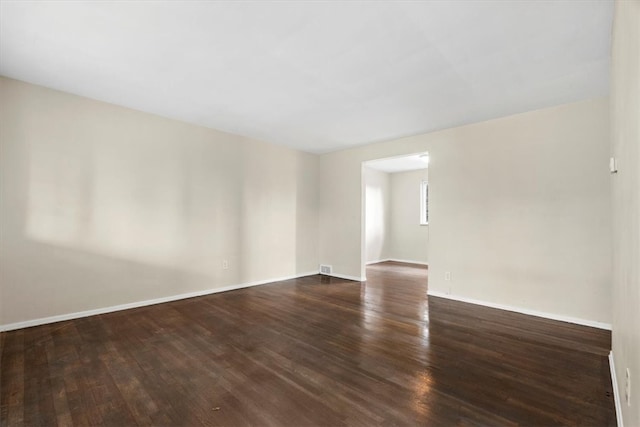 empty room featuring dark hardwood / wood-style flooring