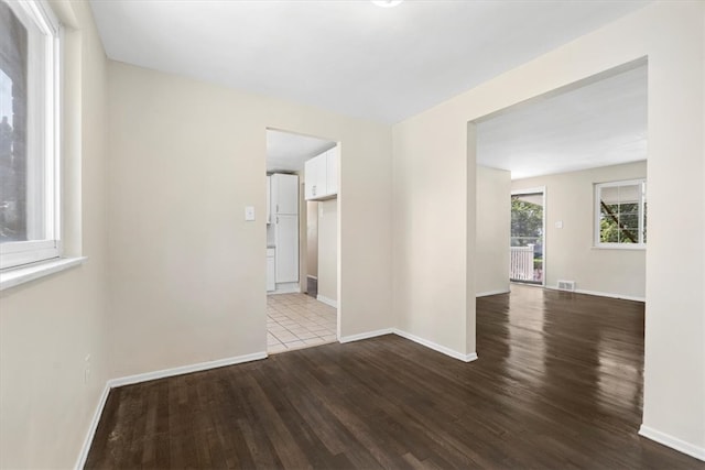 spare room featuring wood-type flooring