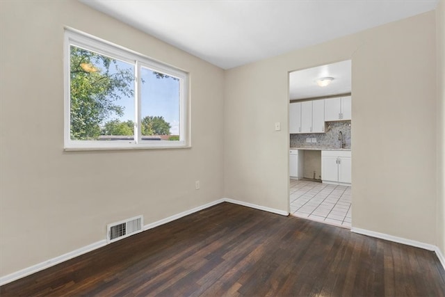 unfurnished room with wood-type flooring