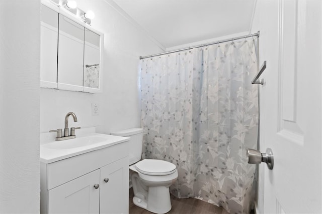 bathroom with a shower with shower curtain, toilet, vanity, crown molding, and hardwood / wood-style flooring