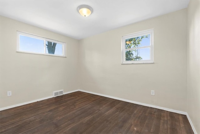 unfurnished room with dark hardwood / wood-style floors