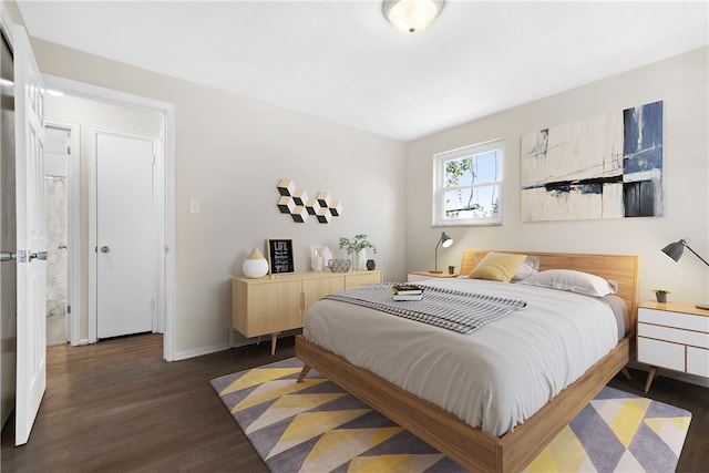 bedroom with dark hardwood / wood-style floors