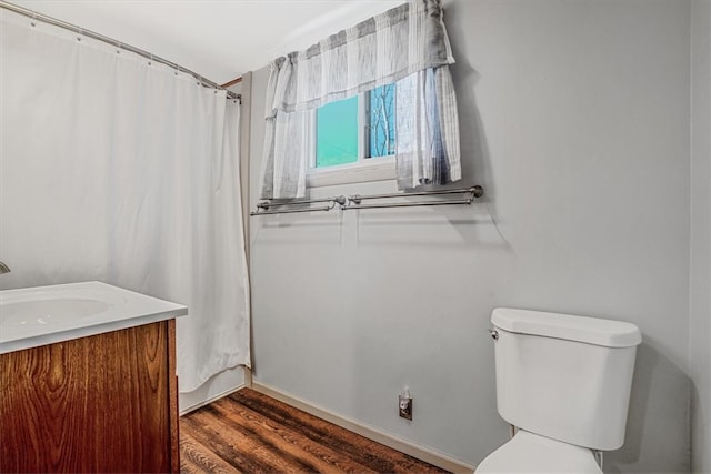 bathroom featuring vanity, toilet, wood-type flooring, and curtained shower