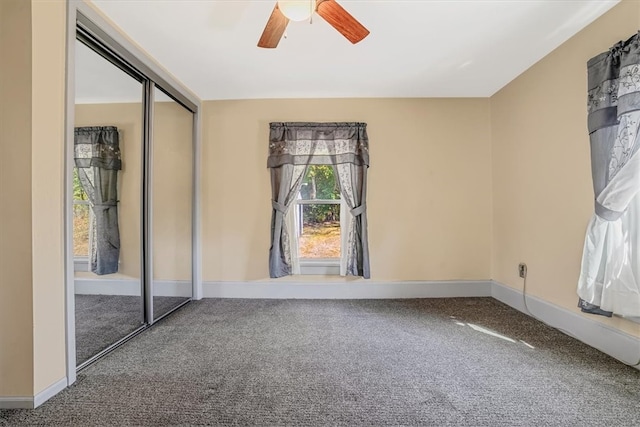 carpeted empty room with ceiling fan