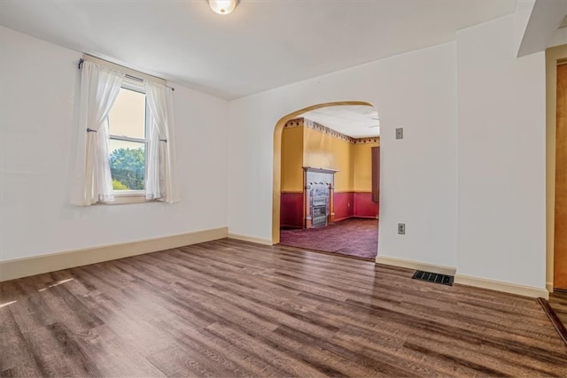 unfurnished room featuring dark wood-type flooring