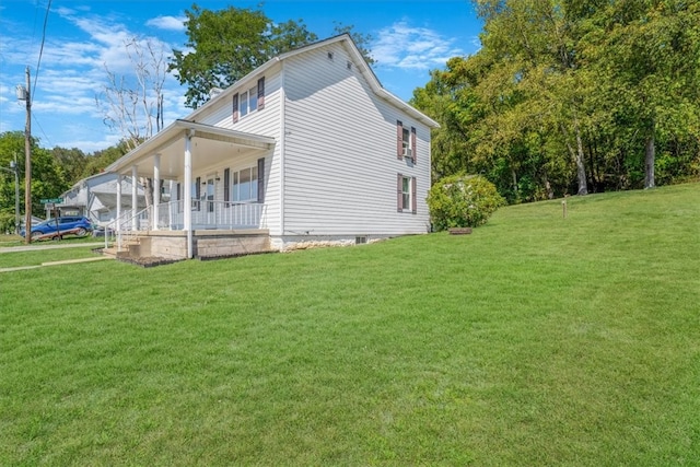 view of home's exterior with a lawn and covered porch