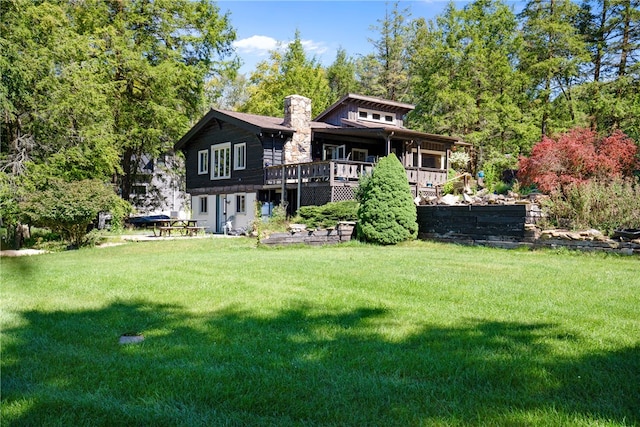 back of house featuring a yard and a deck