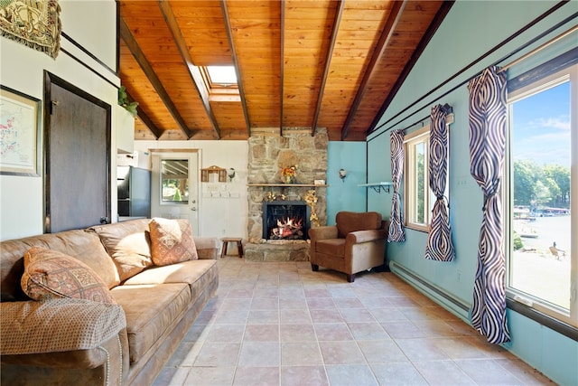 living room featuring vaulted ceiling with skylight, a stone fireplace, wooden ceiling, and light tile patterned flooring