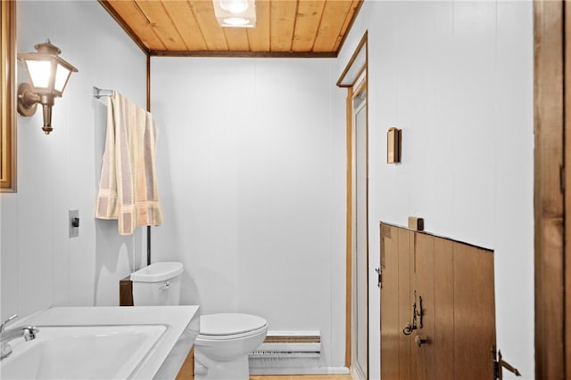 bathroom featuring wooden ceiling, toilet, baseboard heating, ornamental molding, and vanity